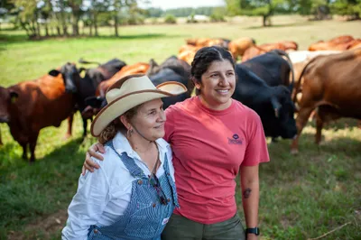 Maria Contreras, left, and her daughter, Lorena Jenkins, stand for a portrait after feeding cattle at their family farm in Blevins, Ark. on Sept. 7, 2023. Photo by Rory Doyle.
